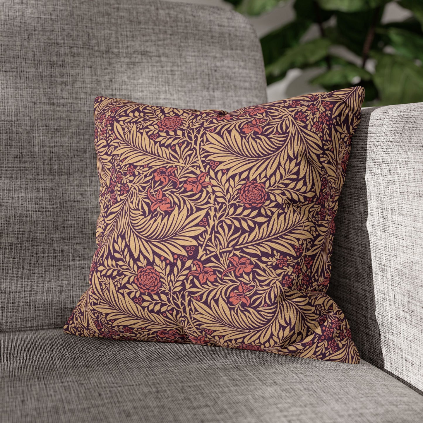 Decorative pillow with leaf pattern on a gray sofa