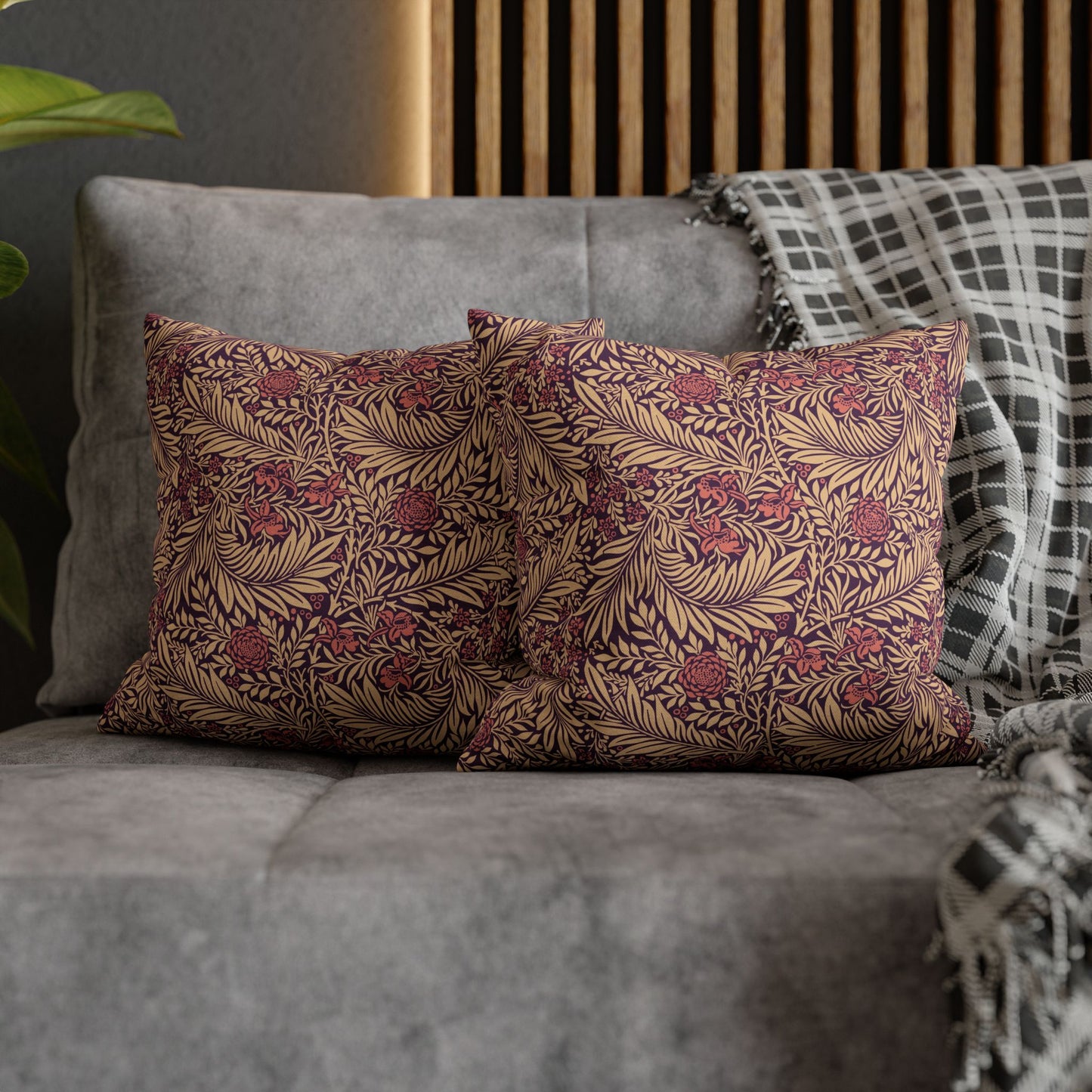 Decorative pillows with floral pattern on a gray sofa