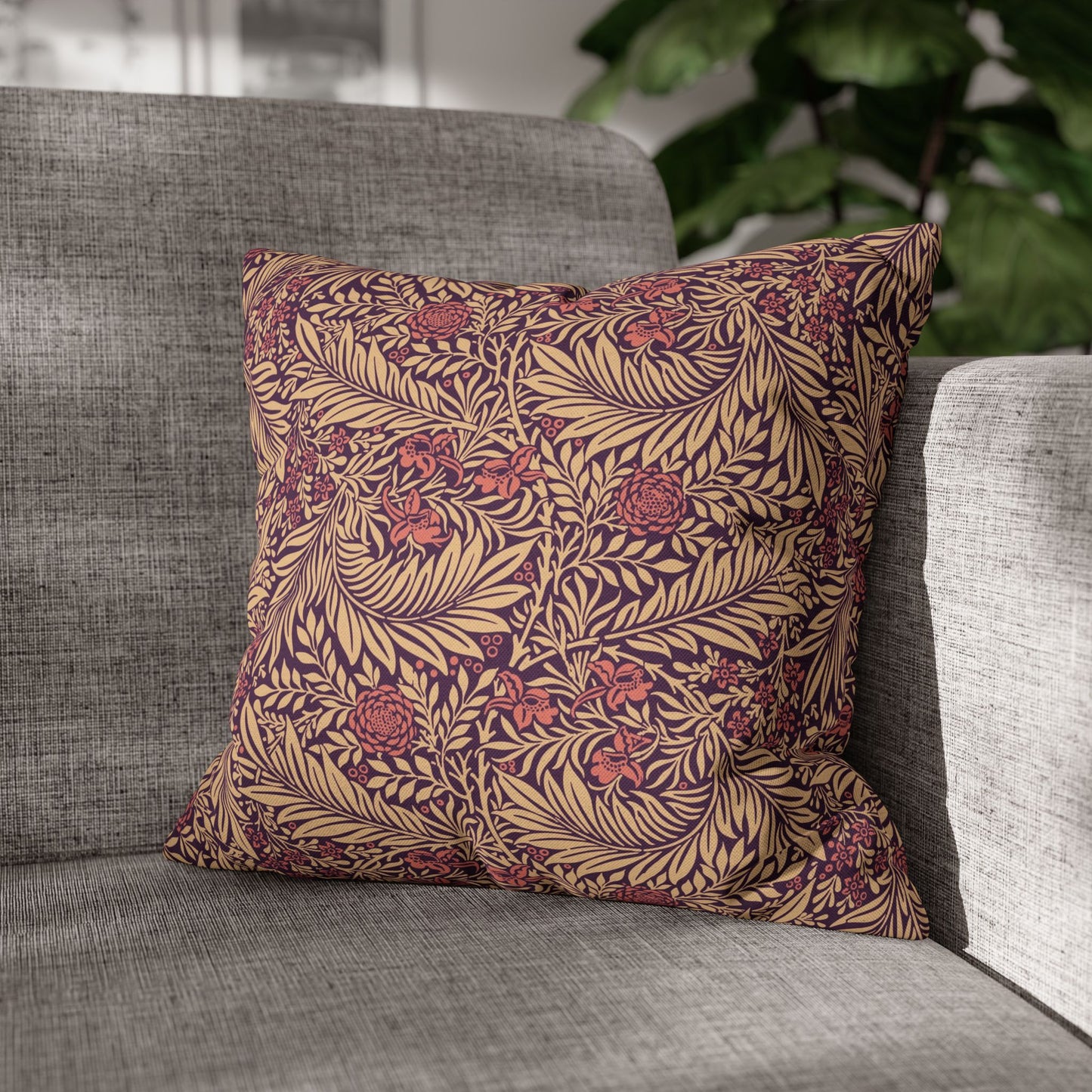 Decorative pillow with leaf pattern on a gray sofa