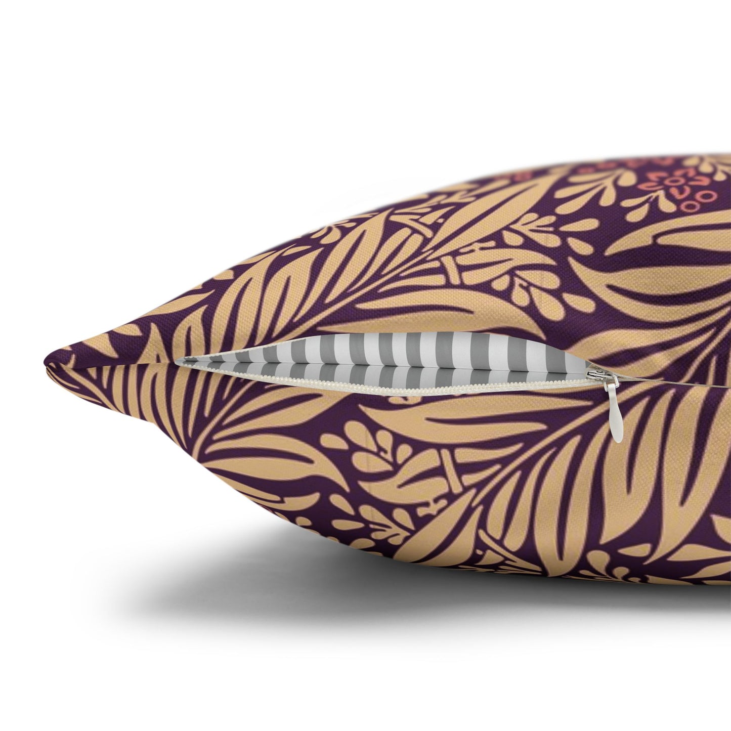 Decorative pillow with gold leaf pattern on a purple background