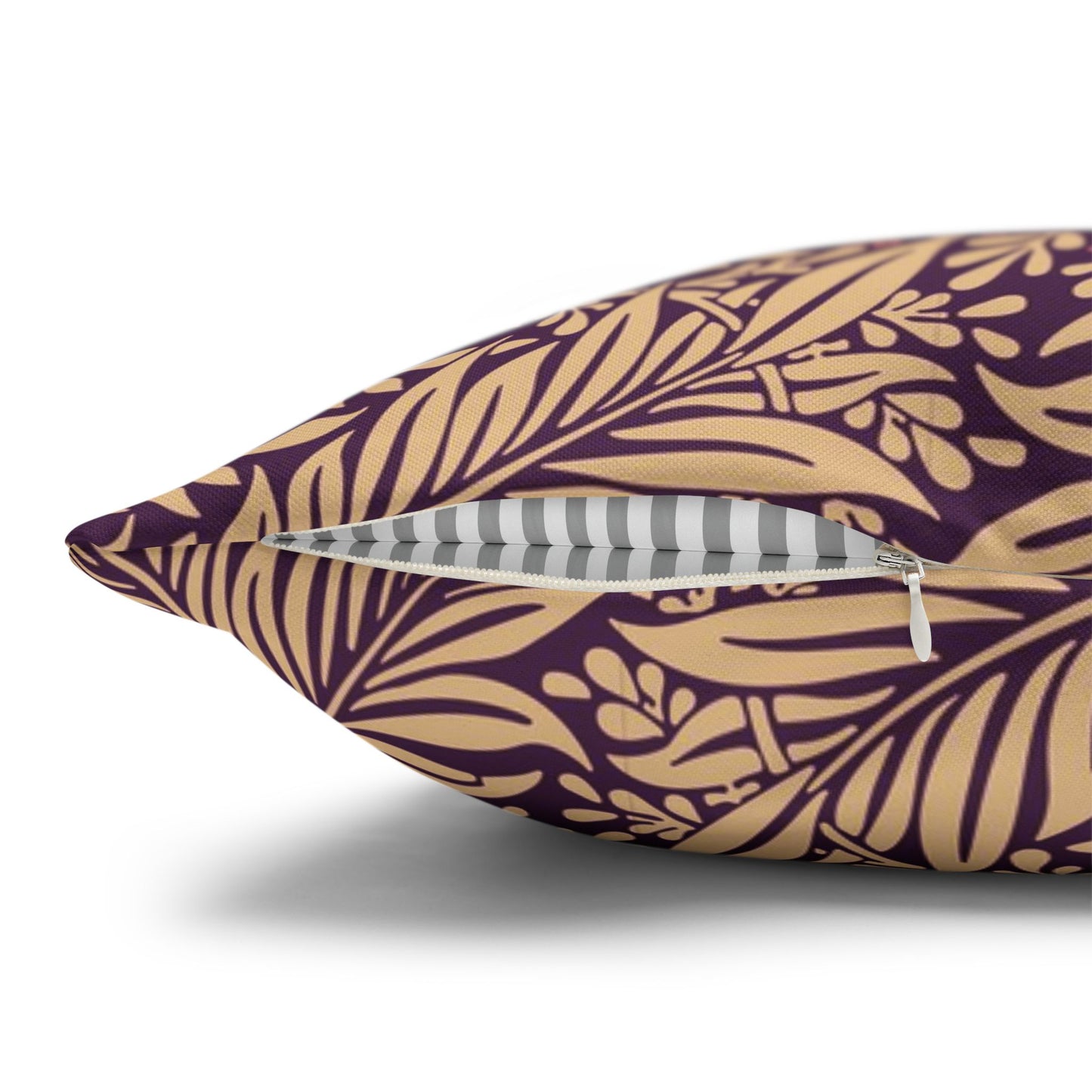 Decorative pillow with gold leaf pattern on a purple background