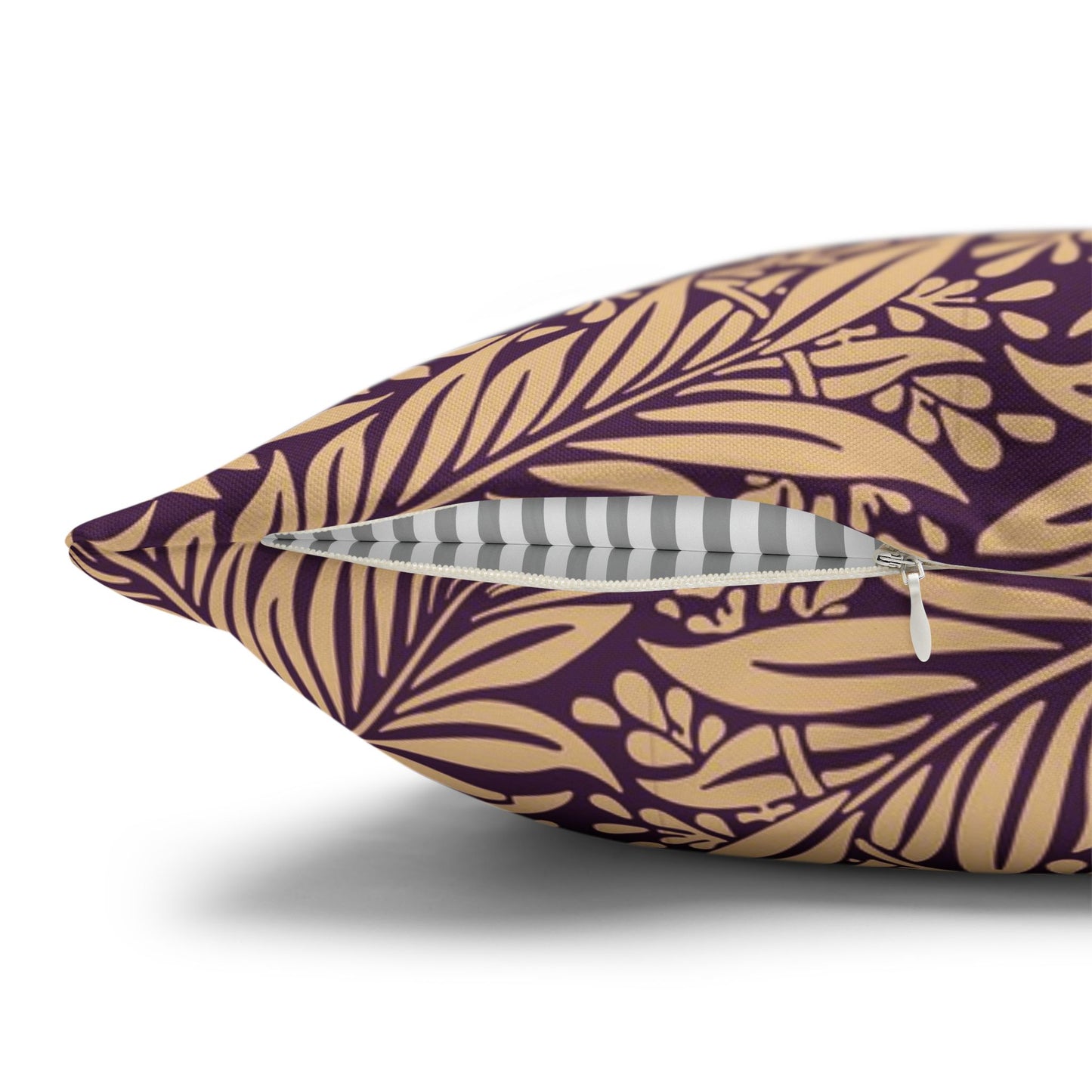 Decorative pillow with gold leaf pattern on a purple background