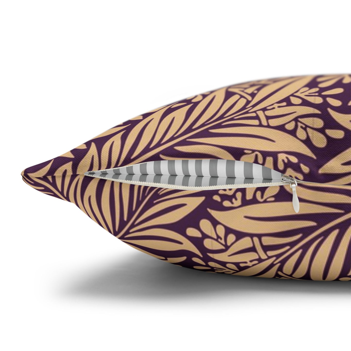 Decorative pillow with gold leaf pattern on a purple background