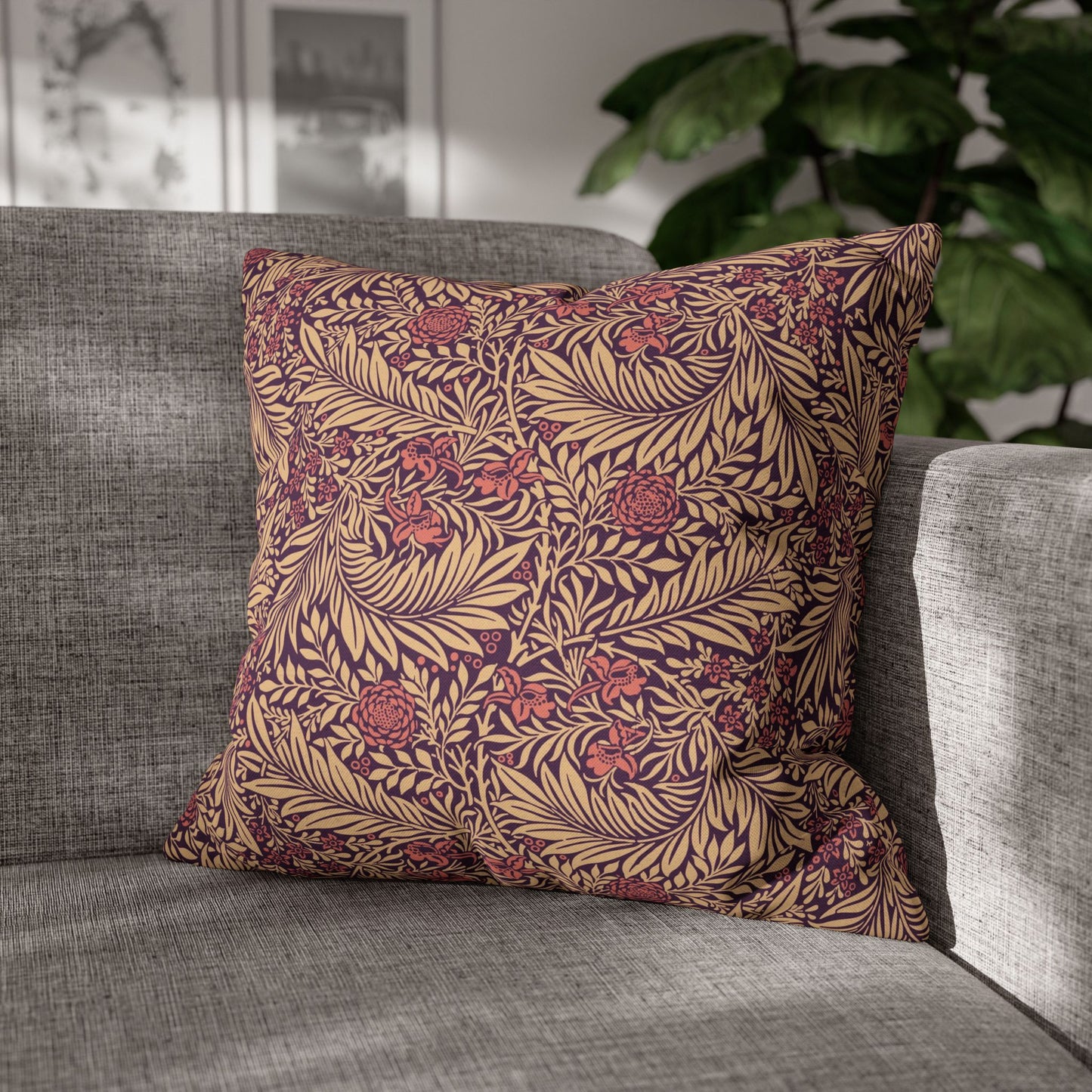 Decorative pillow with a leaf pattern on a gray sofa
