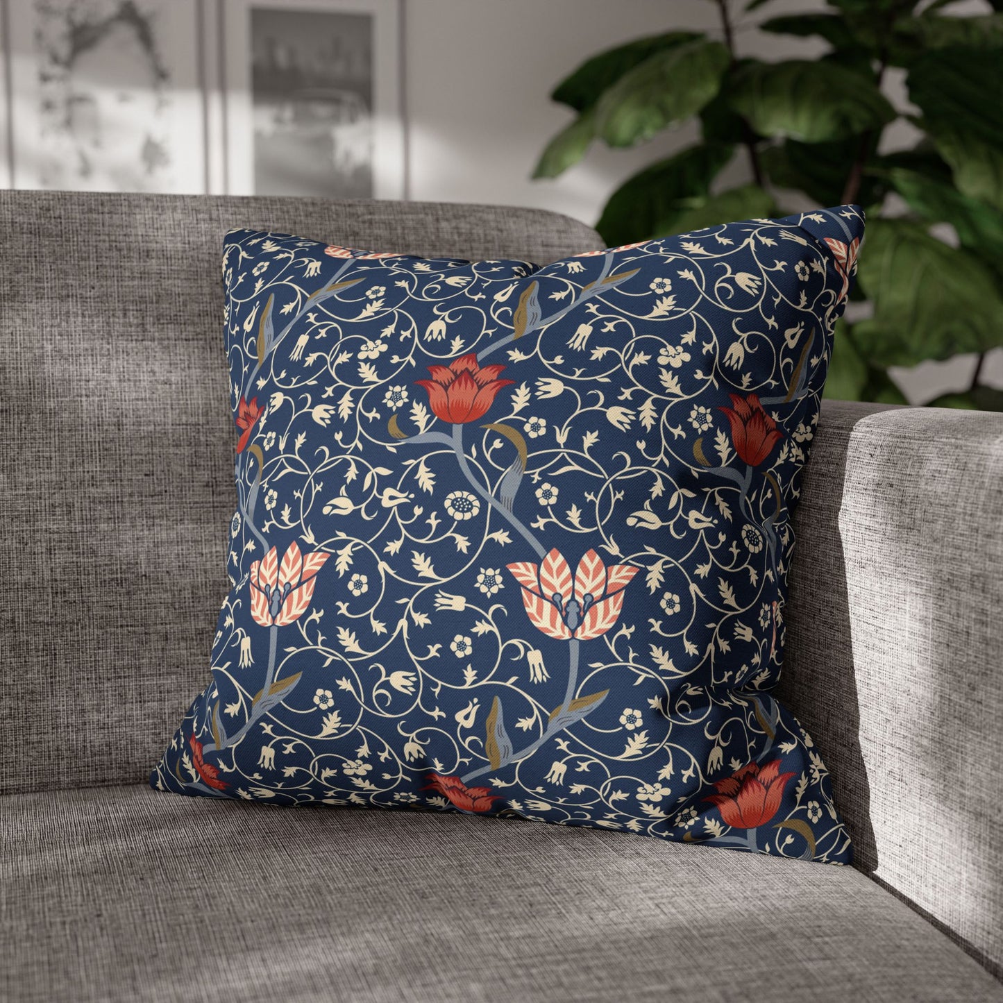 Decorative pillow with floral pattern on a gray sofa