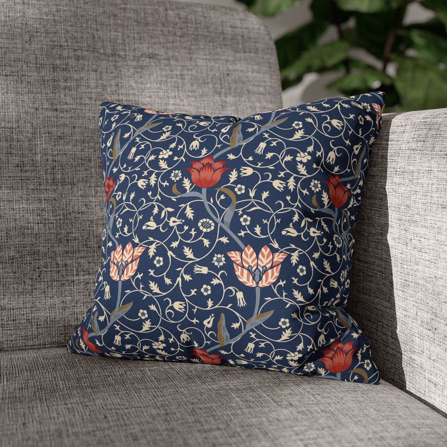 Decorative pillow with floral pattern on a gray sofa