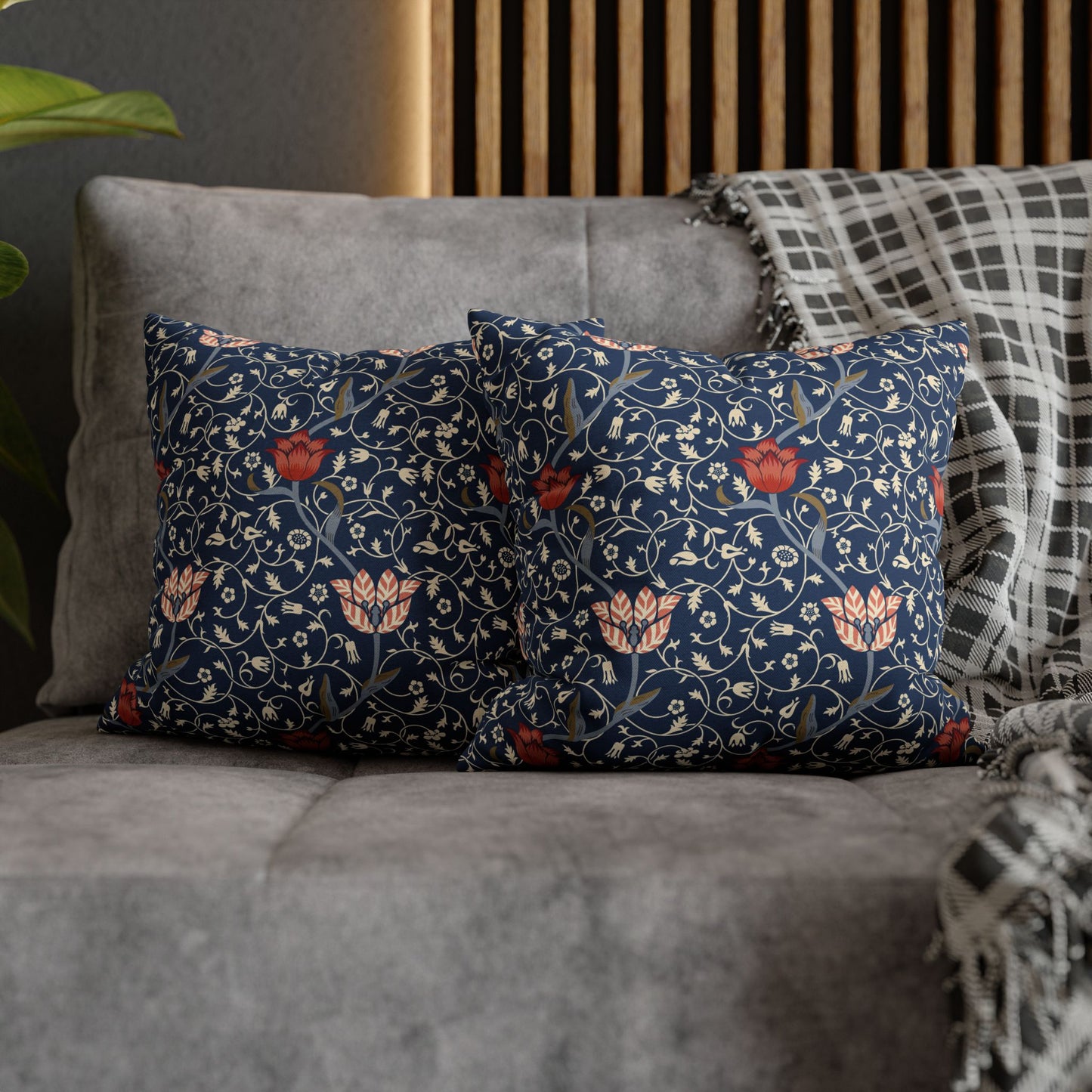 Decorative pillows with floral pattern on a gray sofa