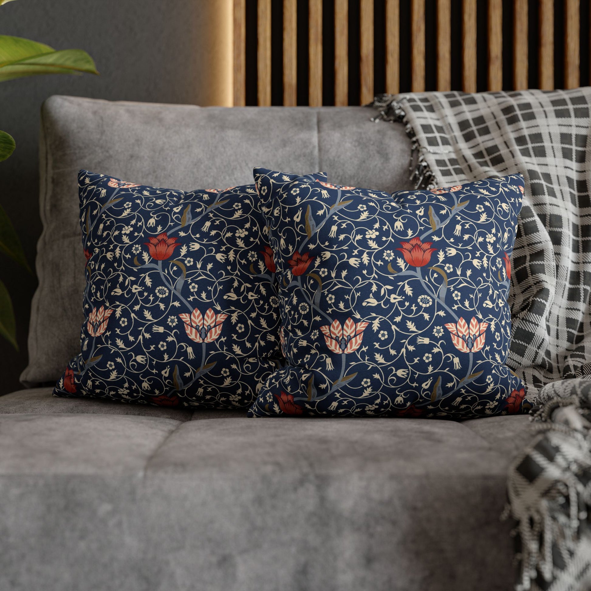 Decorative pillows with floral pattern on a gray sofa