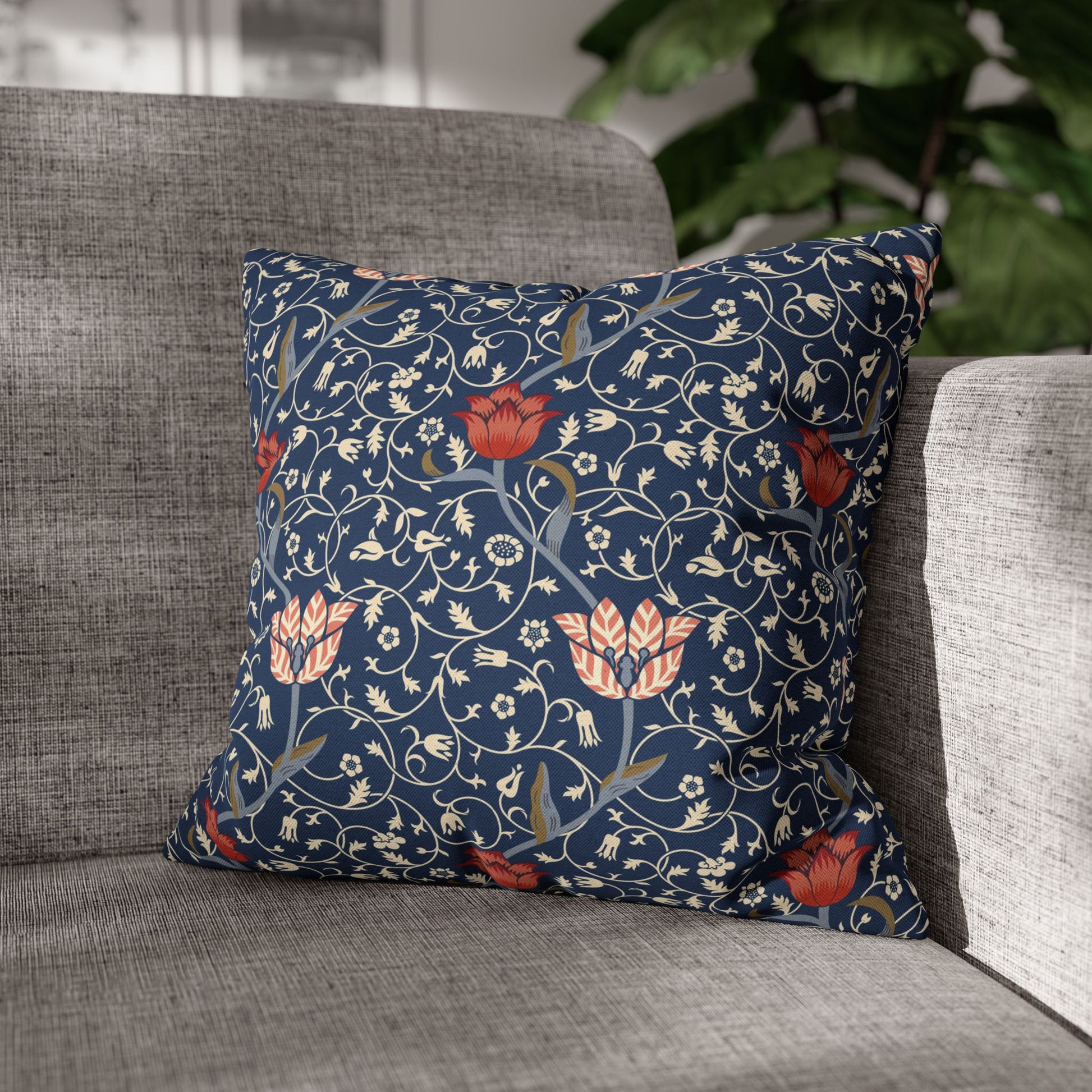Decorative pillow with floral pattern on a gray sofa