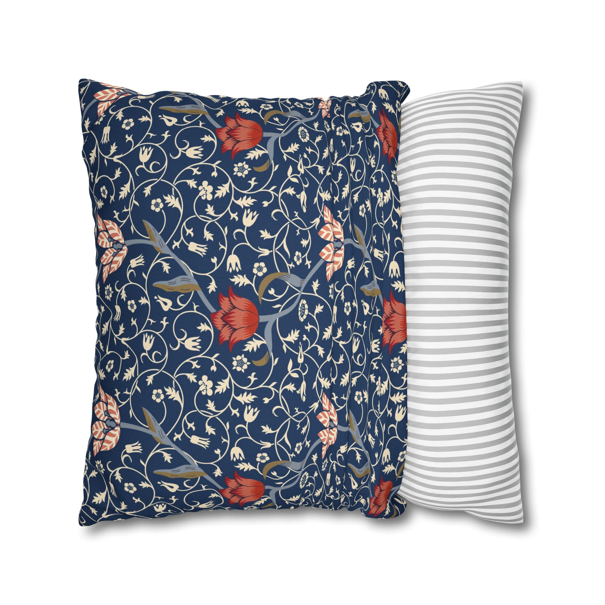 Two pillows, one with floral pattern and one with stripes, on a white background