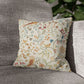 Decorative pillow with floral and bird pattern on a gray sofa