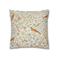 Decorative pillow with floral and bird pattern on a white background