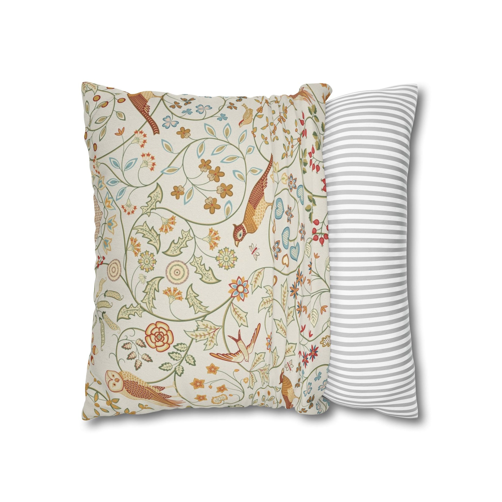 Two pillows, one with floral pattern and one with stripes, on a white background