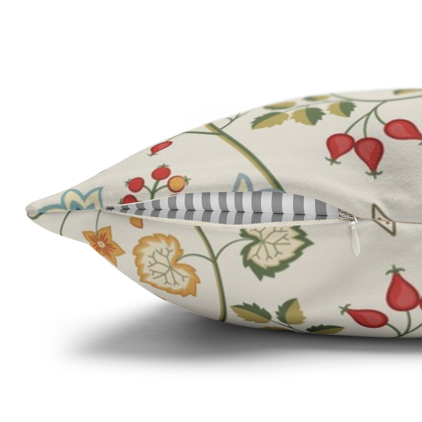Decorative pillow with floral and fruit pattern on a white background