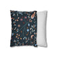 Decorative pillow with floral pattern next to a plain striped pillow on a white background