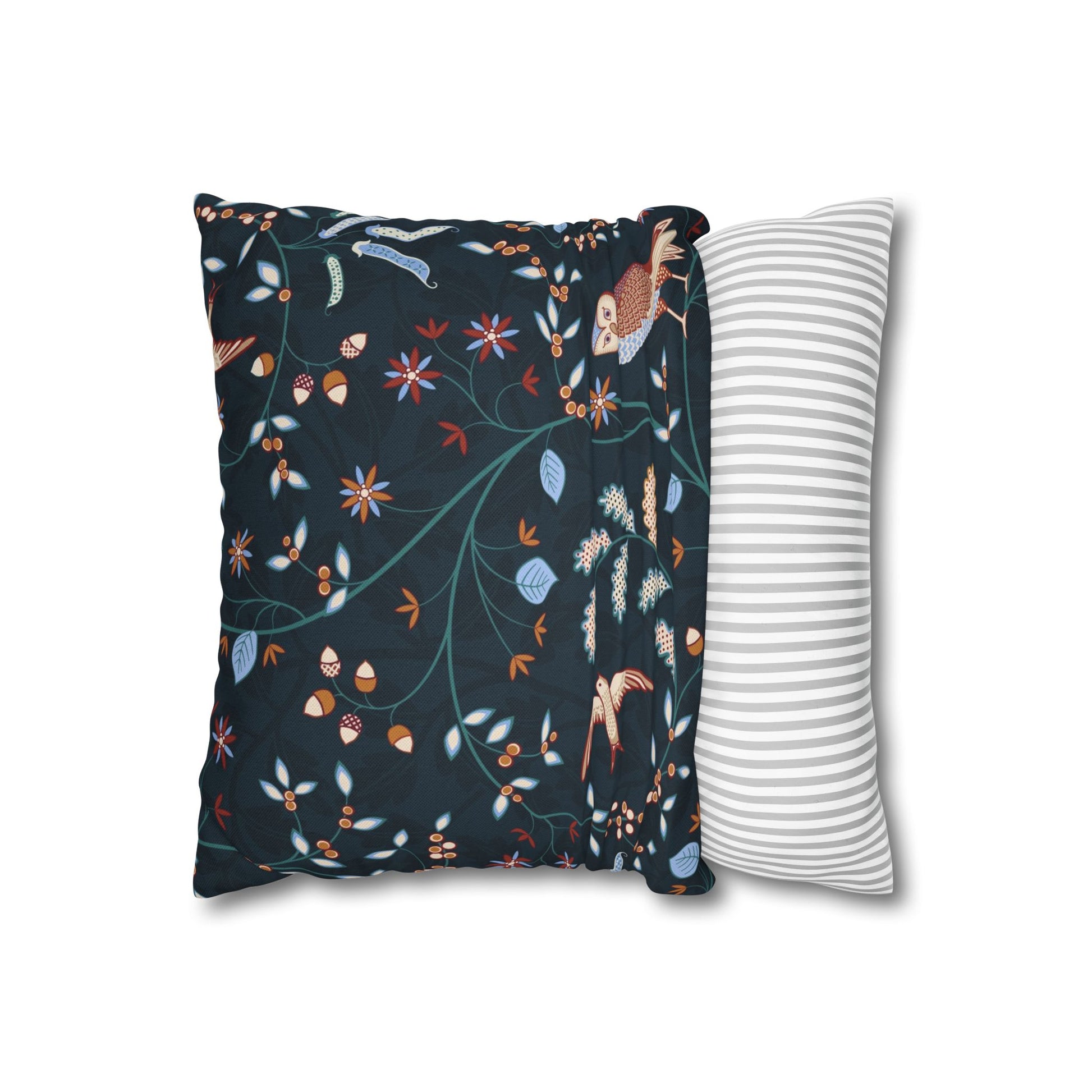 Decorative pillow with floral pattern next to a plain striped pillow on a white background