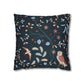 Decorative pillow with nature-themed pattern featuring birds and plants on a dark blue background.