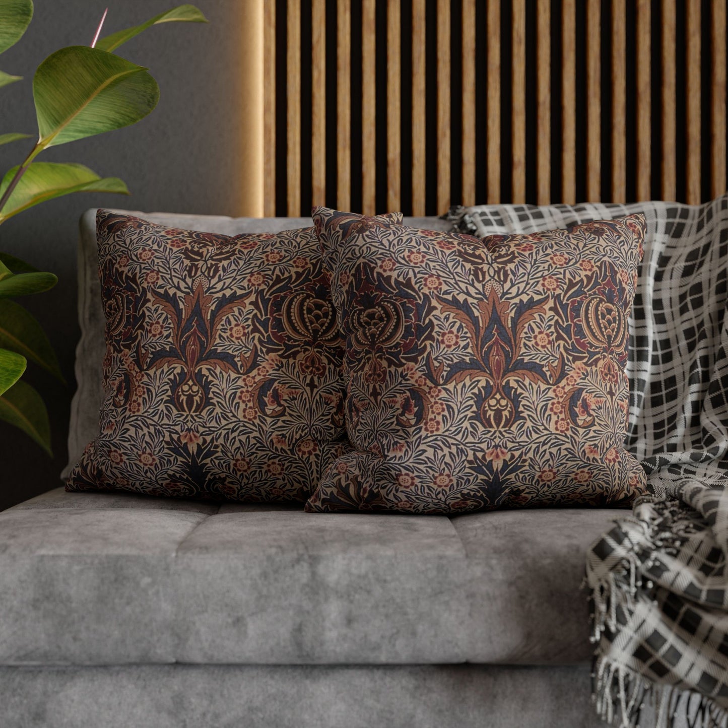 Patterned cushions on a sofa with a plant and wooden headboard in the background