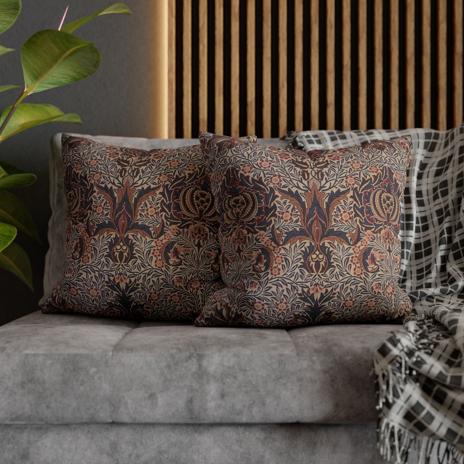 Patterned cushions on a sofa with a plant and wooden headboard in the background