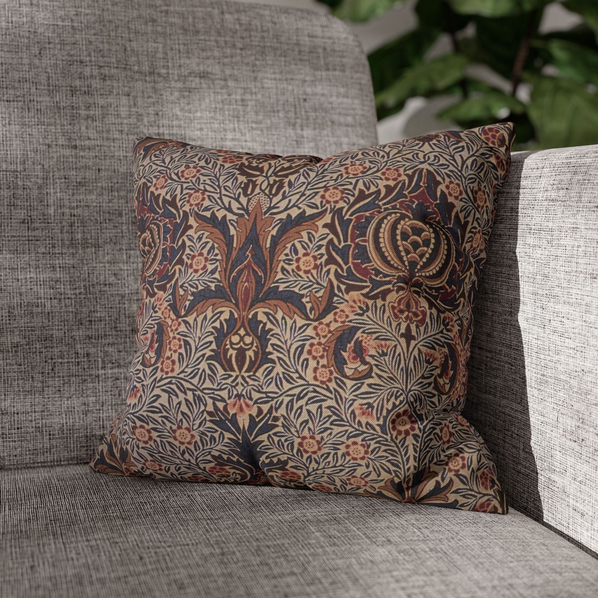 Decorative pillow with floral pattern on a gray sofa