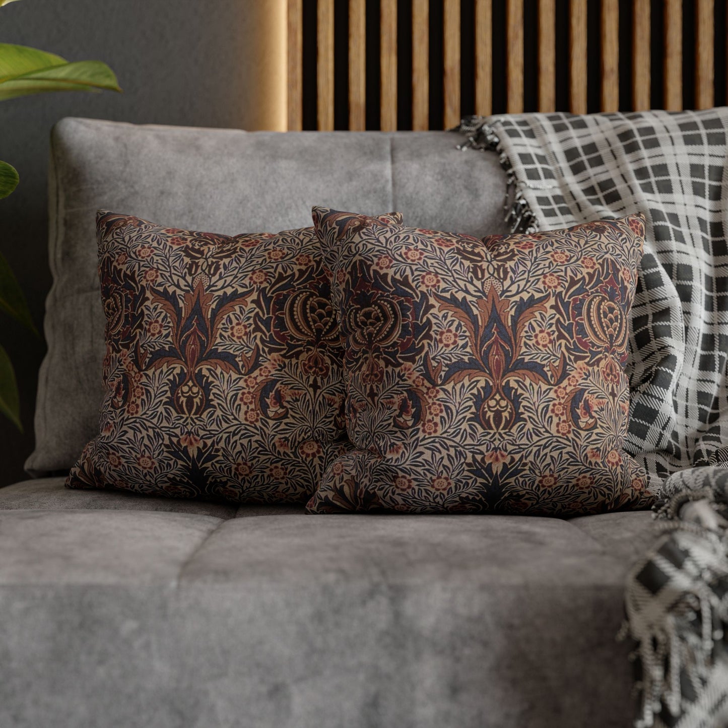 Patterned pillows on a gray sofa with a wooden headboard in the background