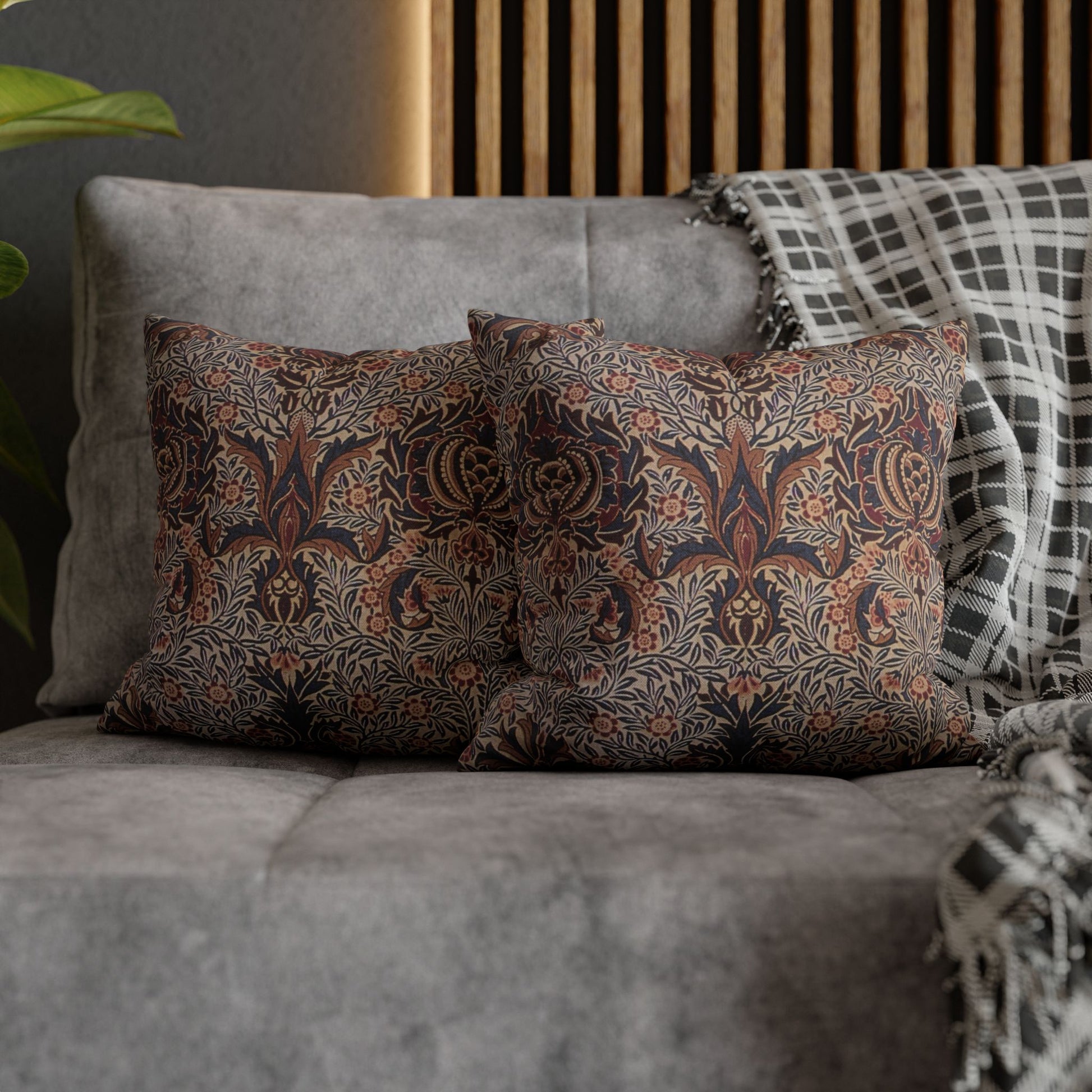 Patterned pillows on a gray sofa with a wooden headboard in the background