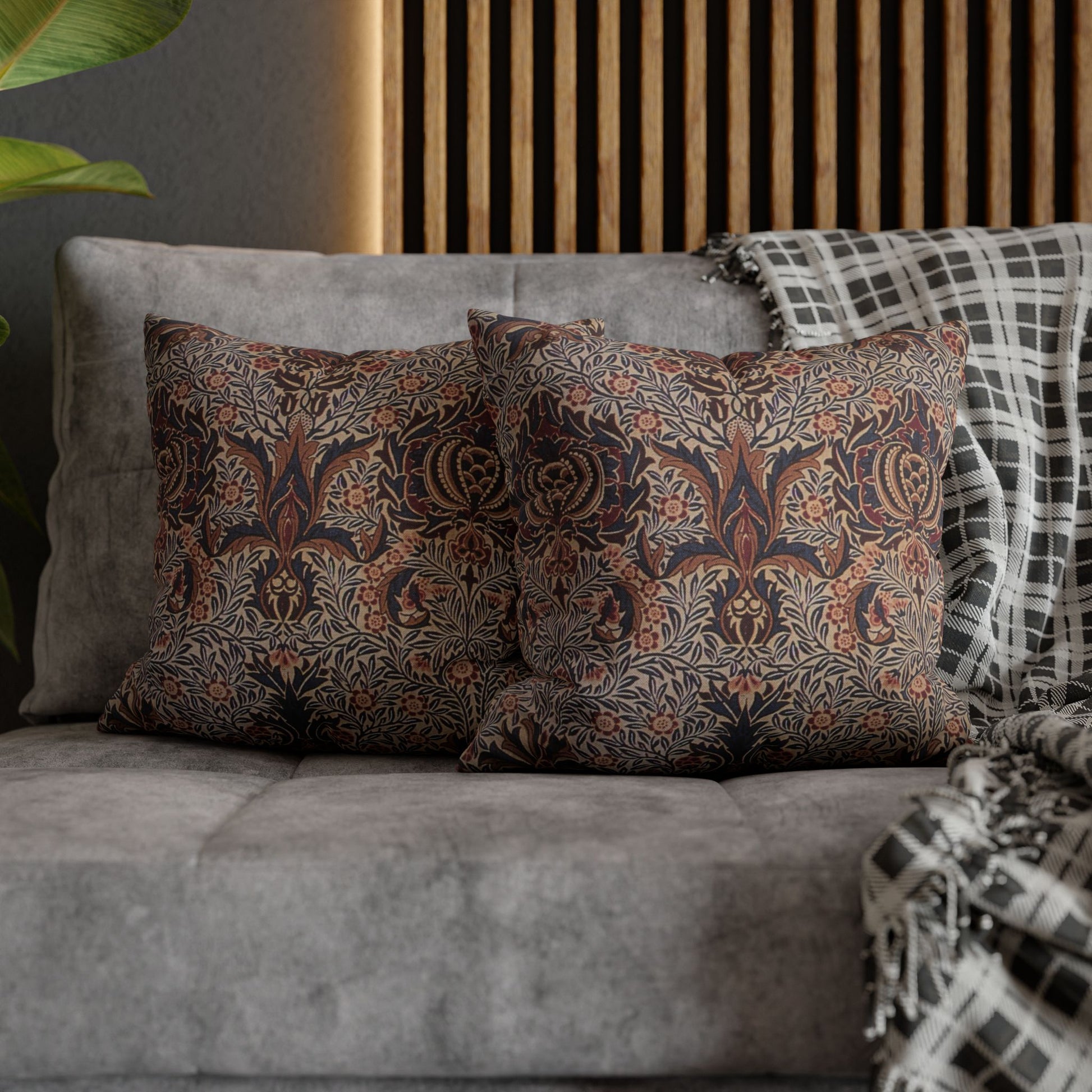 Patterned pillows on a gray sofa with a wooden headboard in the background