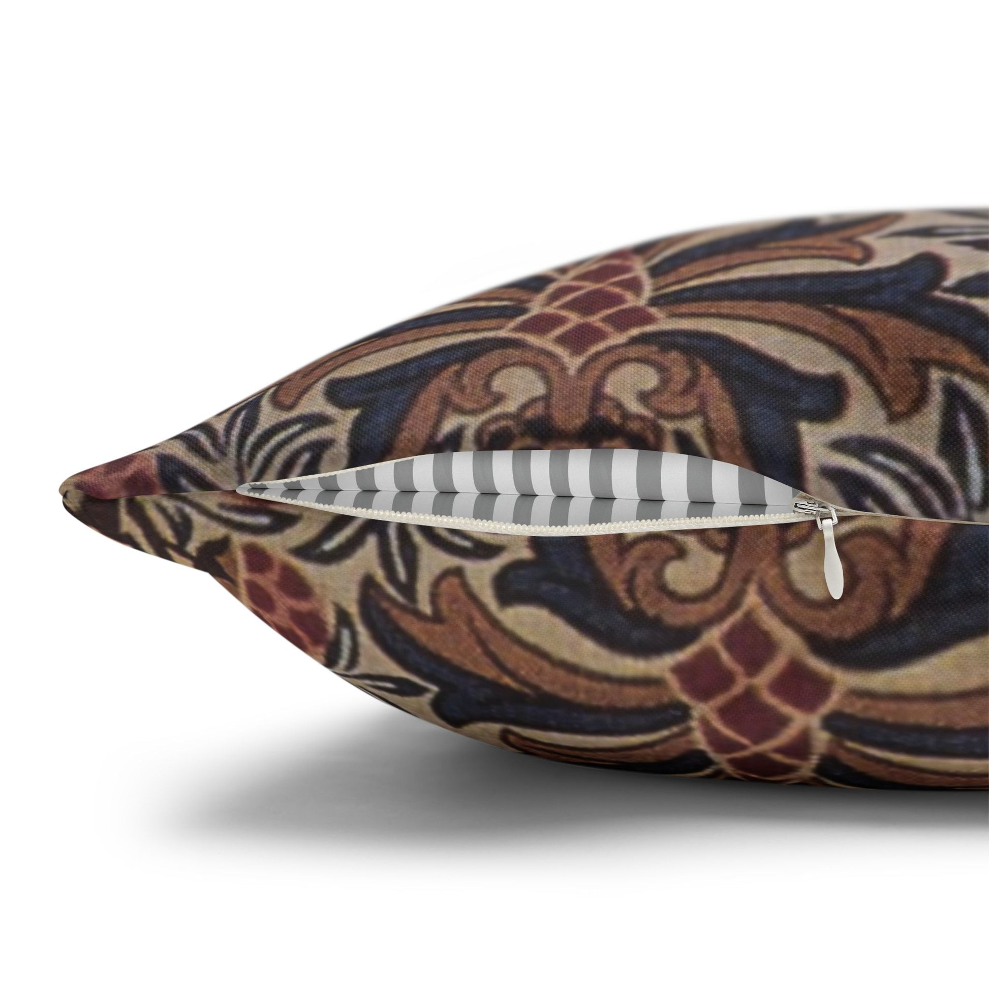 Decorative pillow with intricate patterns and a zipper on a white background