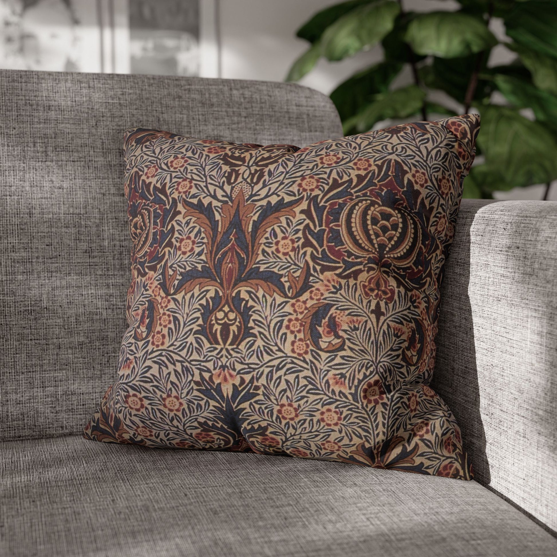 Decorative pillow with floral pattern on a gray sofa