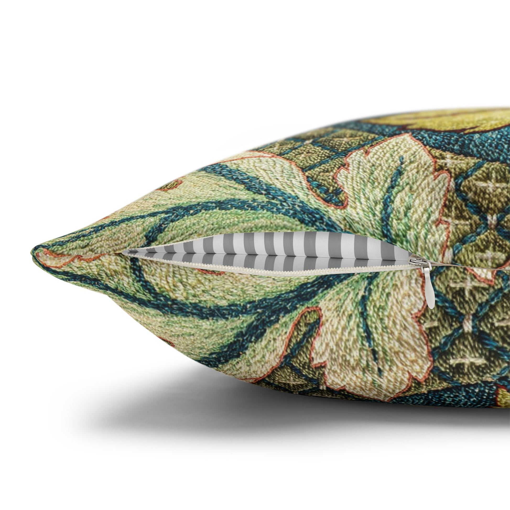 Decorative pillow with intricate leaf pattern and a feather on a white background