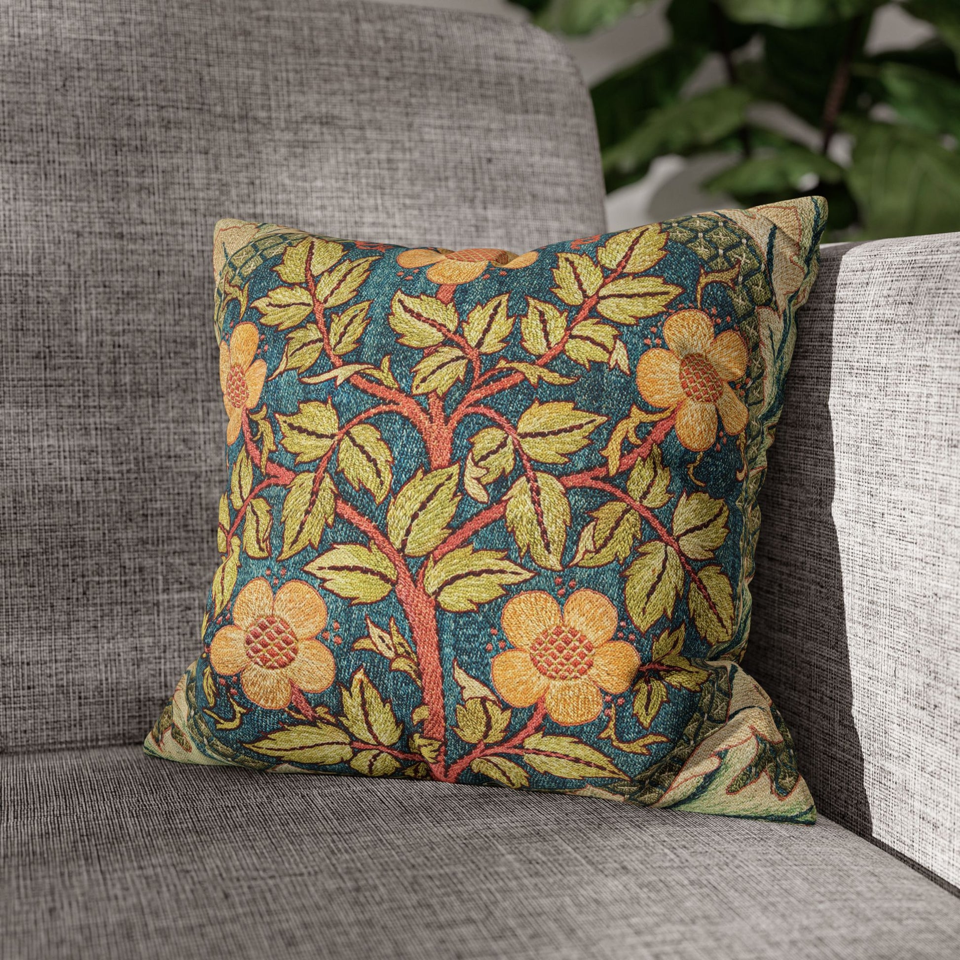Decorative pillow with floral pattern on a gray sofa