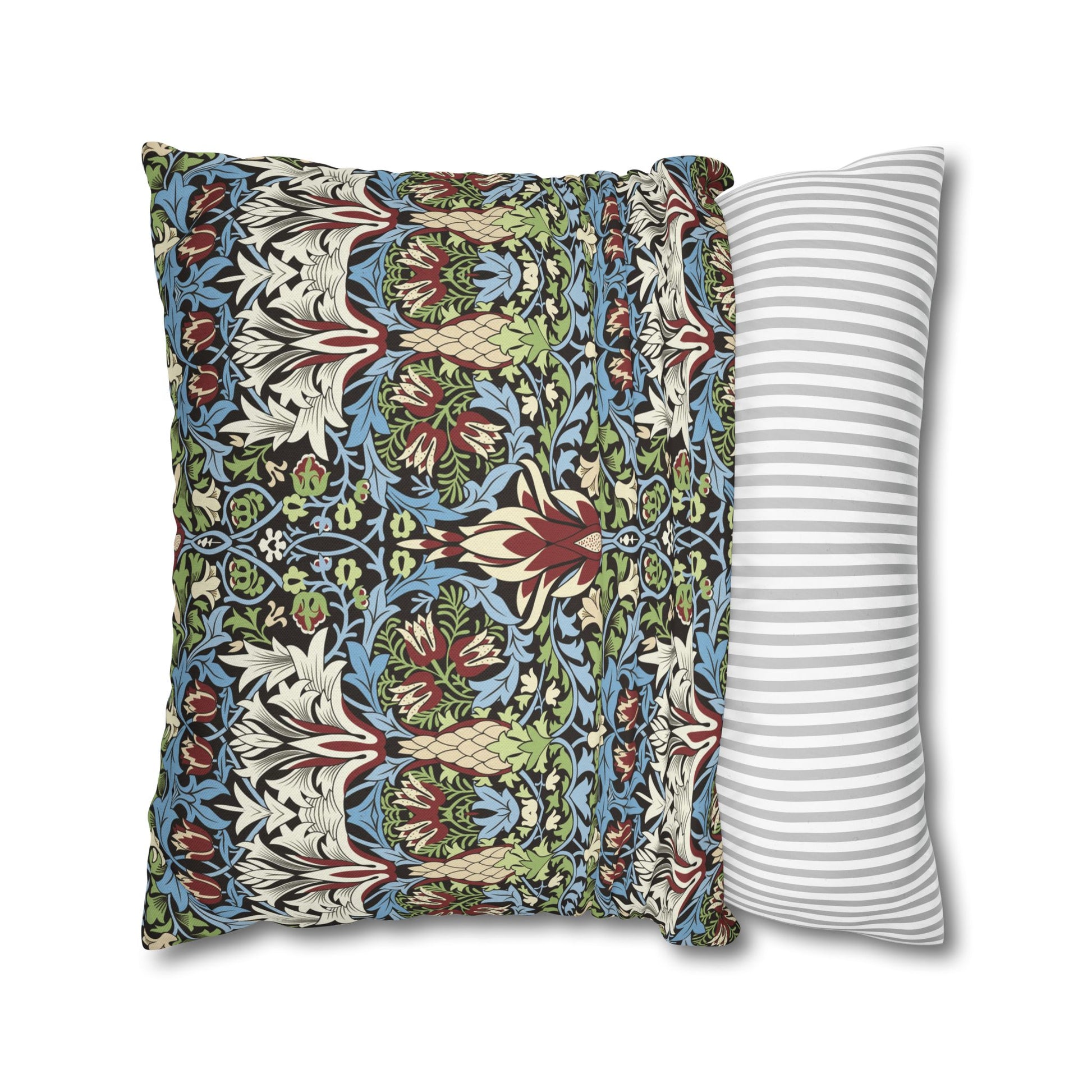 Two pillows, one with a floral pattern and the other with a striped pattern, on a white background - William Morris Snakeshead.