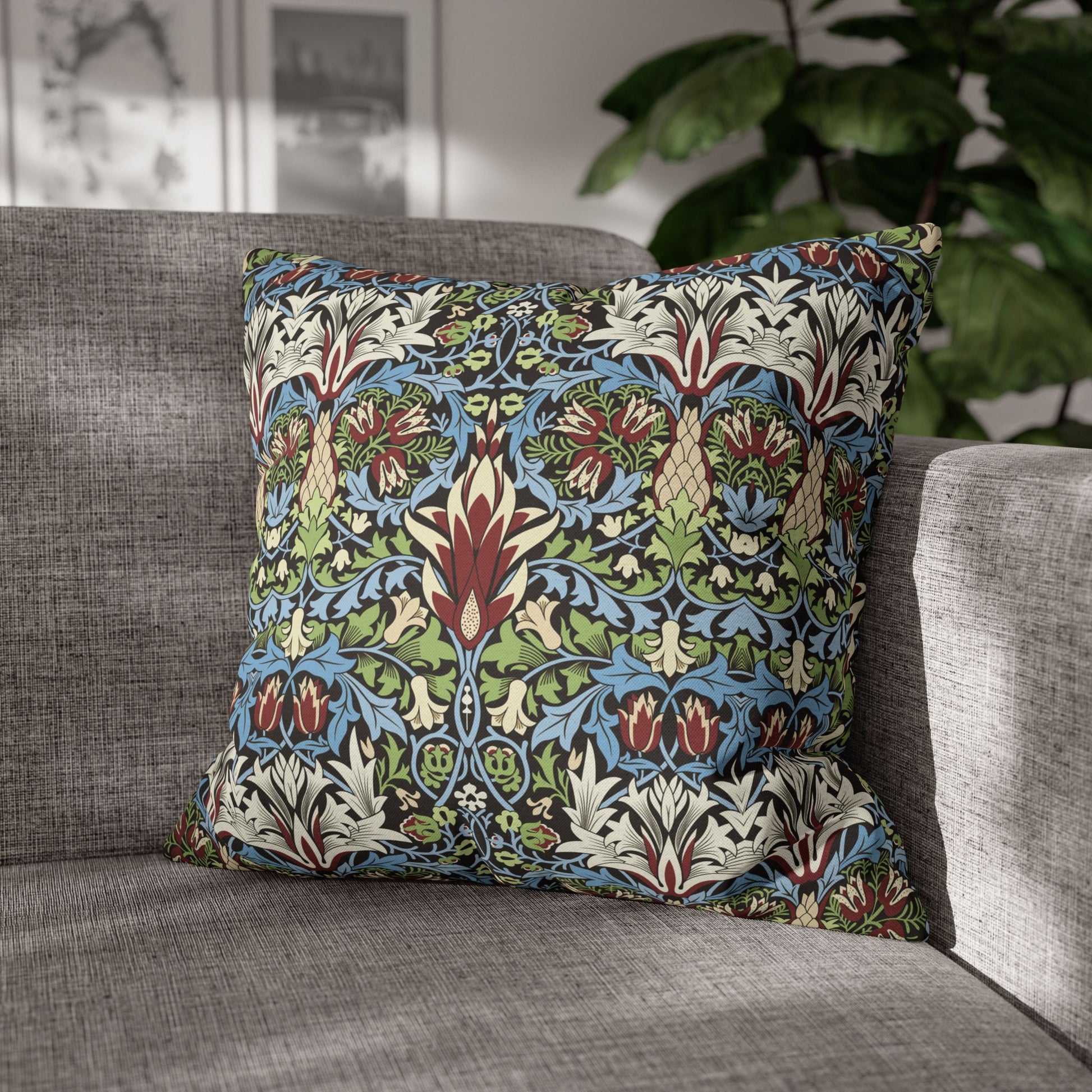 Decorative pillow with floral pattern on a gray sofa - William Morris Snakeahead