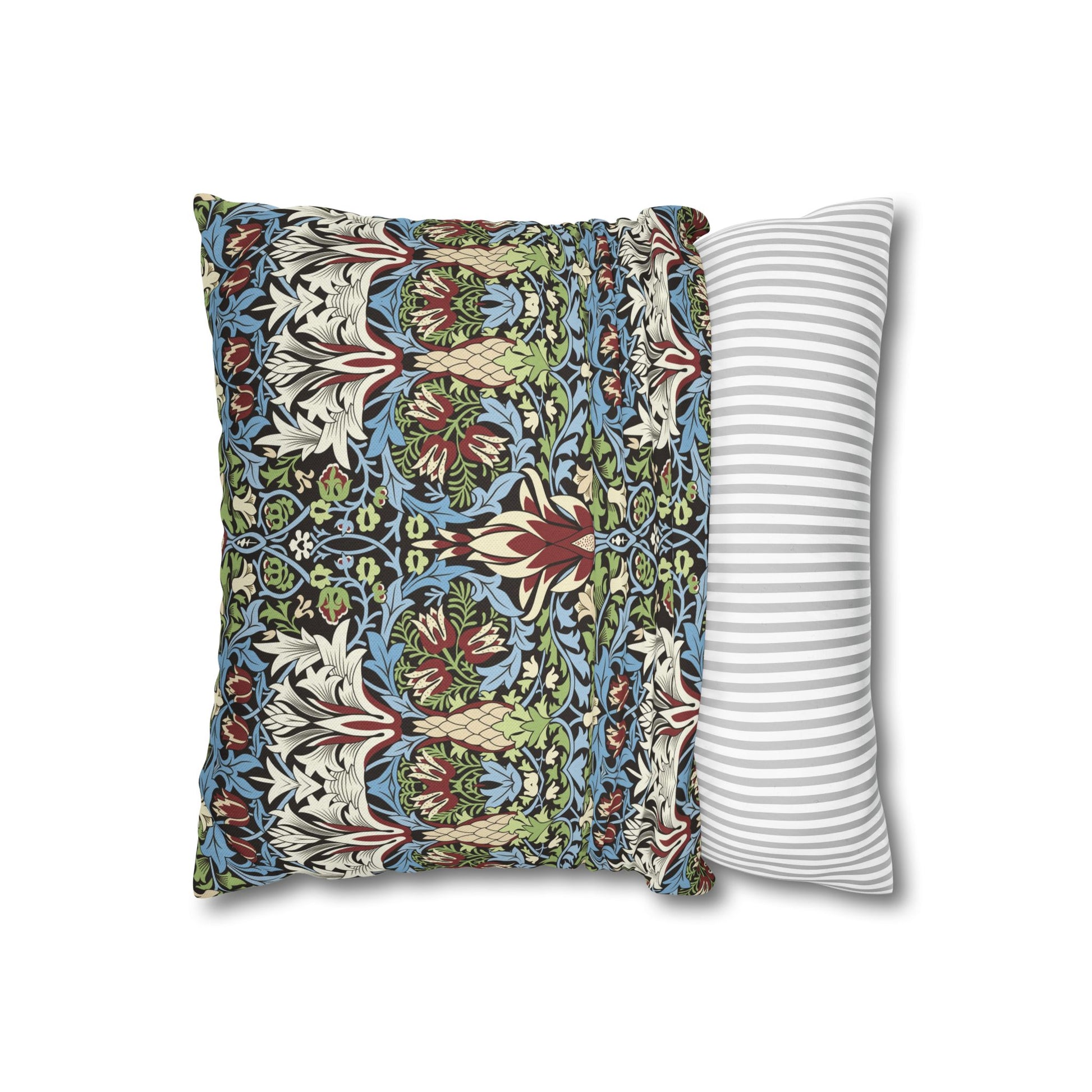 Decorative pillow with floral pattern next to a striped pillow on a white background - William Morris Snakeshead