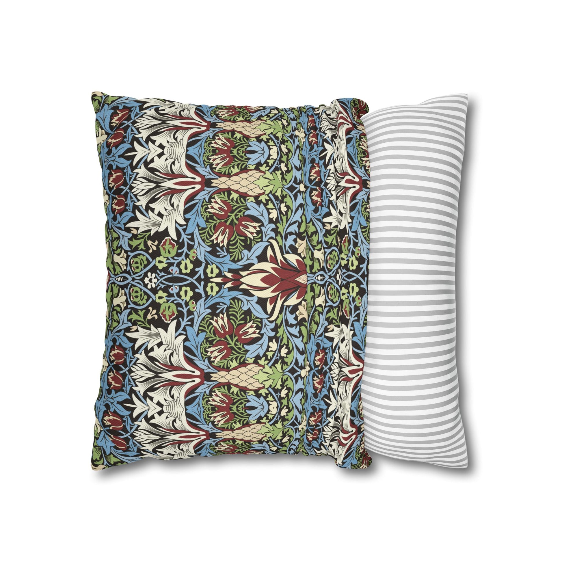 Decorative pillow with floral pattern next to a striped pillow on a white background - William Morris Snakeshead
