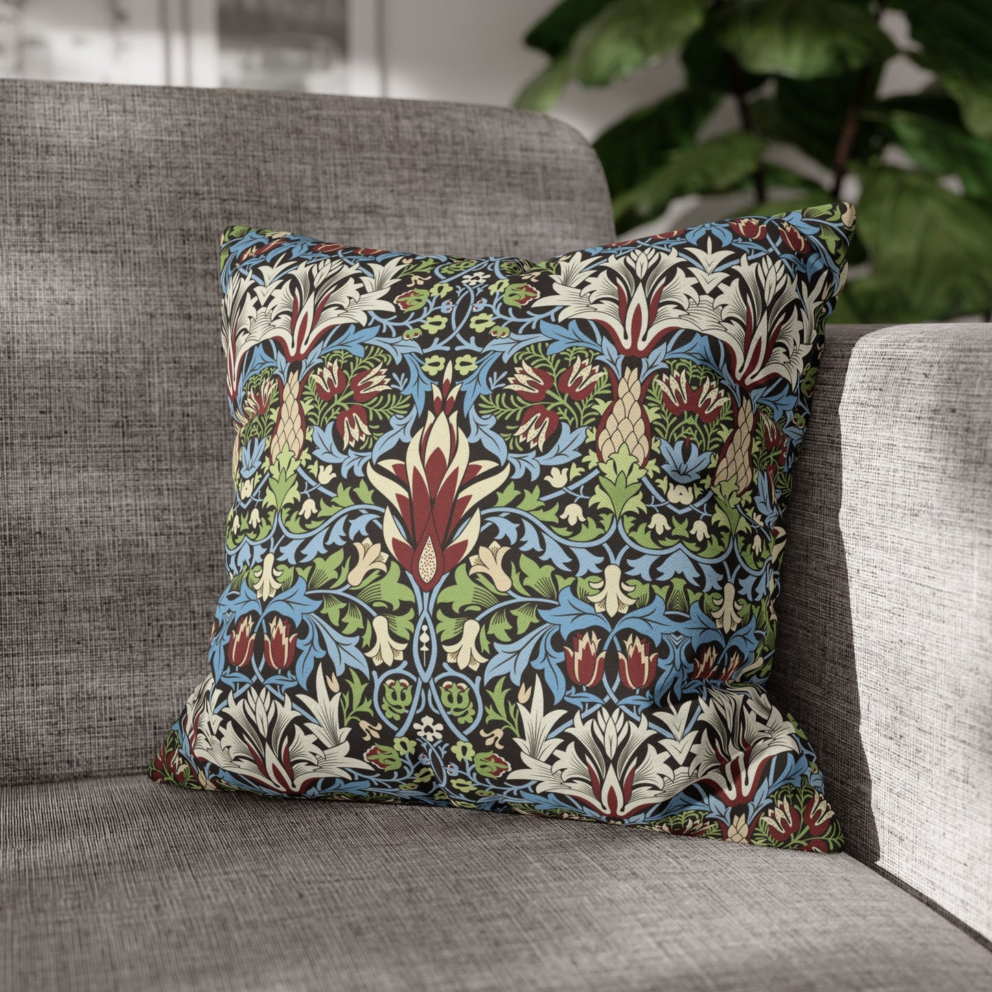 Decorative pillow with floral pattern on a gray sofa - William Morris Snakeshead