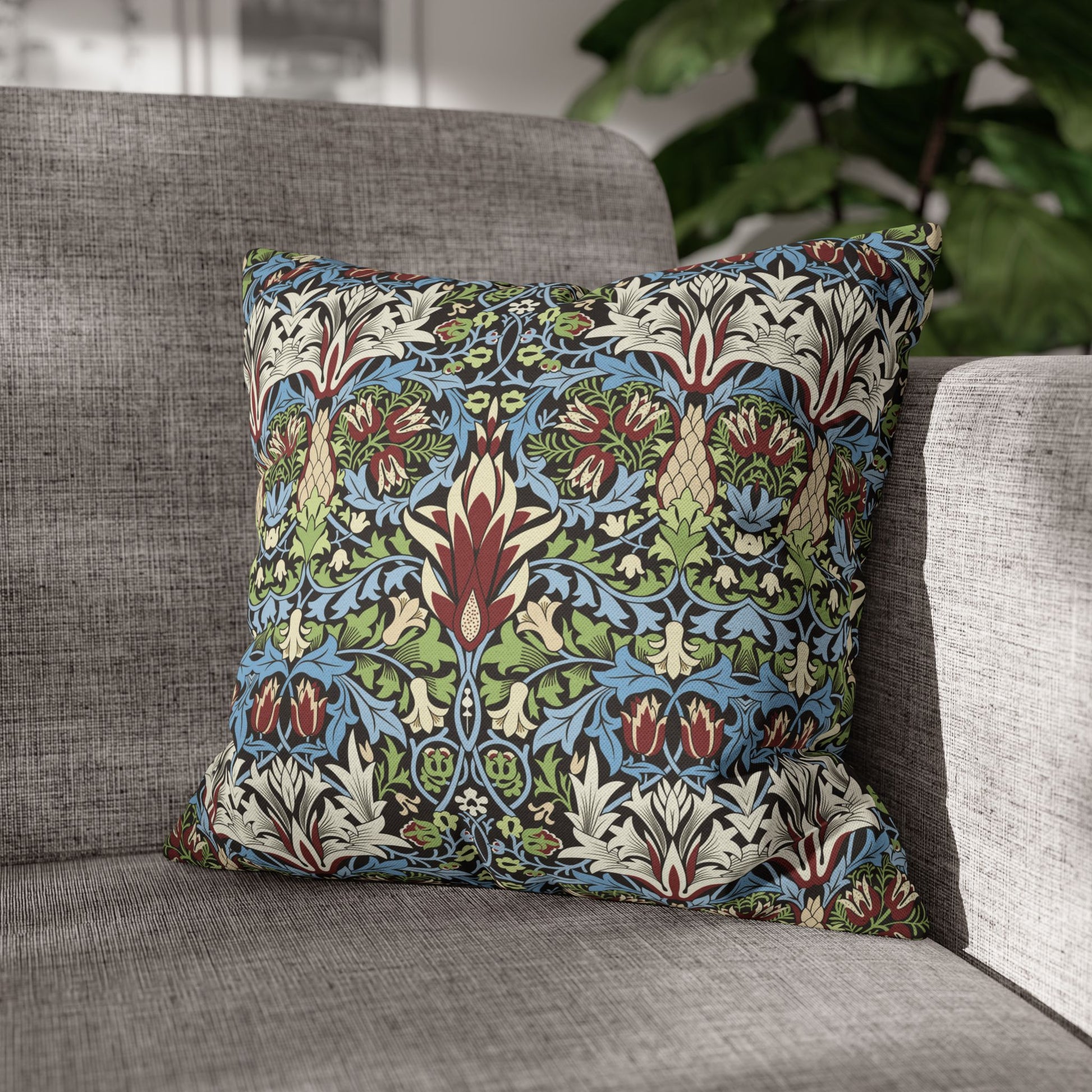 Decorative pillow with floral pattern on a gray sofa - William Morris Snakeshead