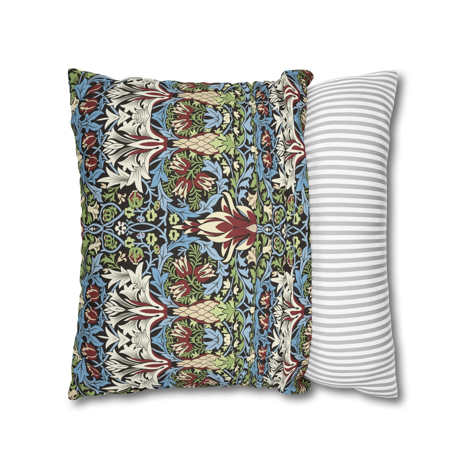 Decorative pillow with floral pattern next to a striped pillow on a white background - William Morris Snakeshead