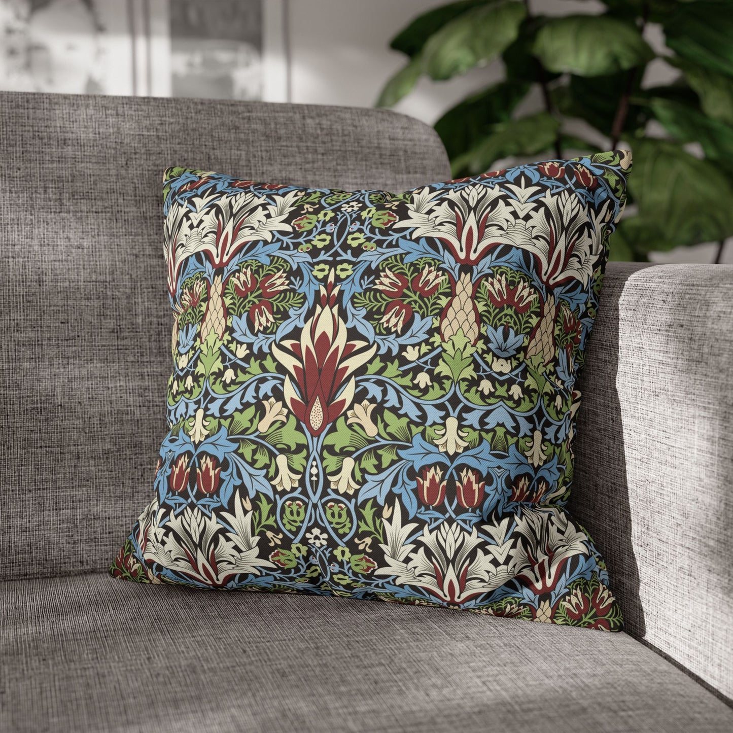 Decorative pillow with floral pattern on a gray sofa - William Morris Snakeshead