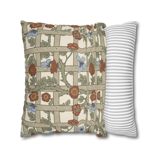 Decorative pillow with floral and lattice design next to a striped pillow on a white background