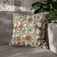 Decorative pillow with floral and butterfly pattern on a gray sofa