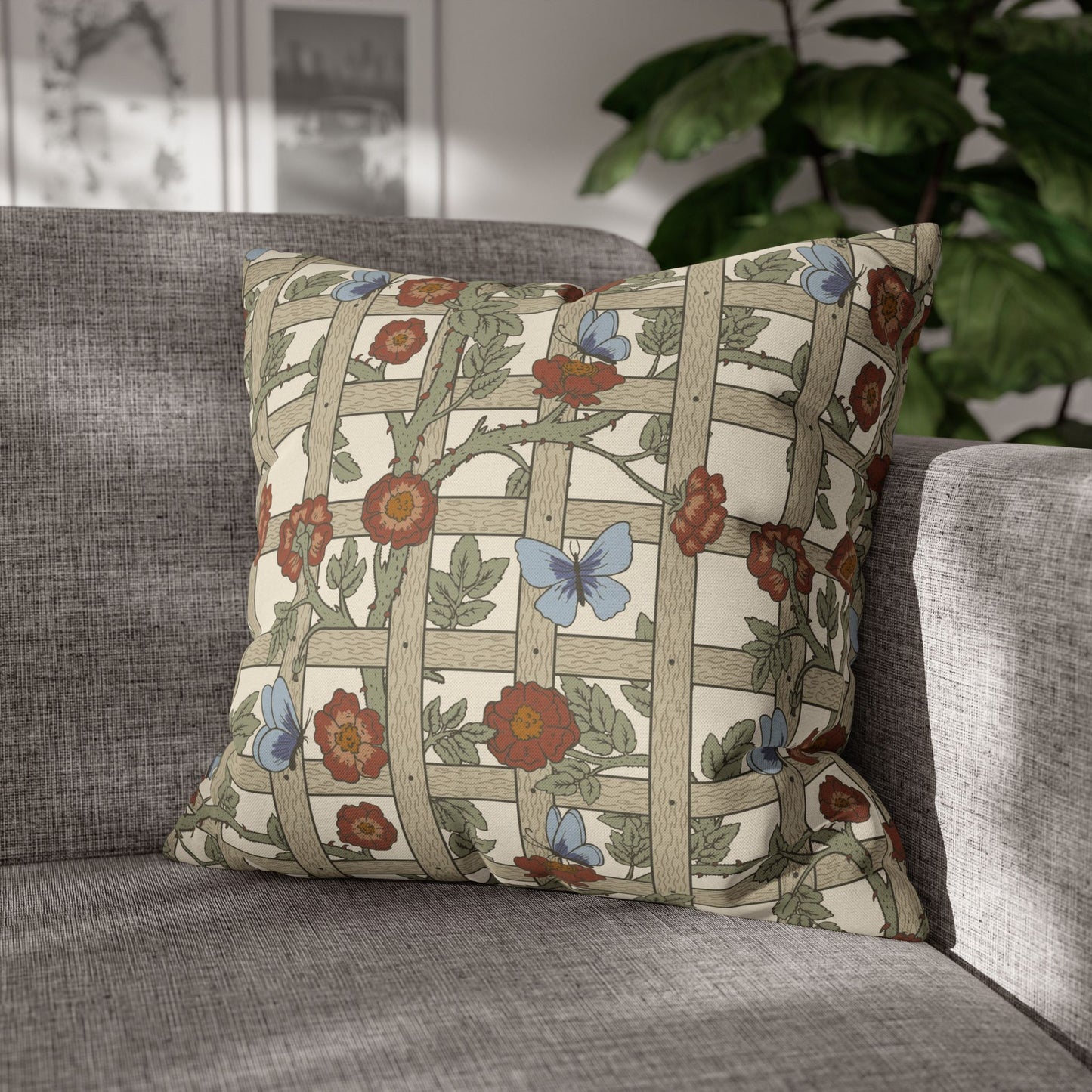 Decorative pillow with floral and butterfly pattern on a gray sofa