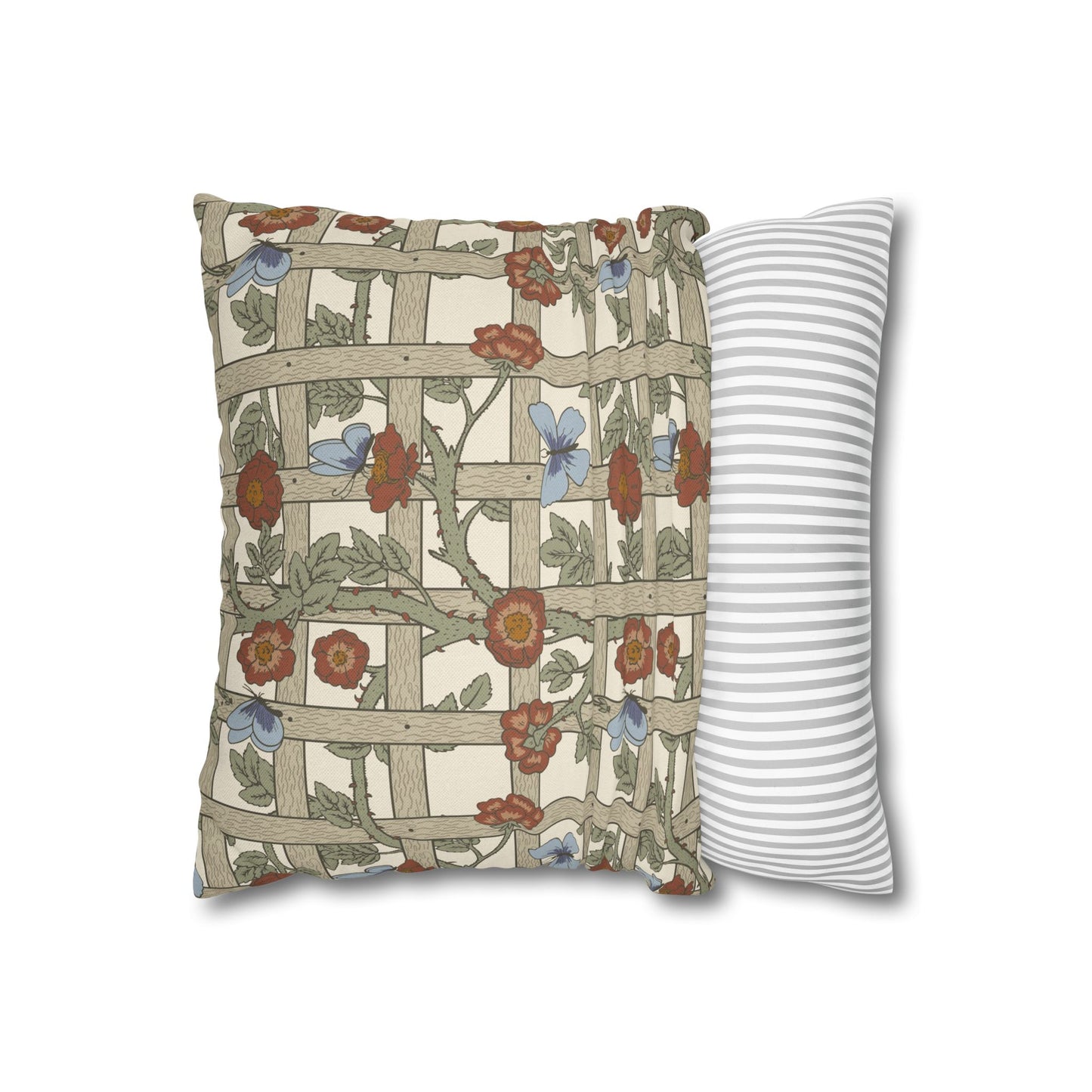 Decorative pillow with floral and lattice pattern next to a plain striped pillow on a white background