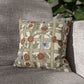 Decorative pillow with floral and butterfly pattern on a gray sofa