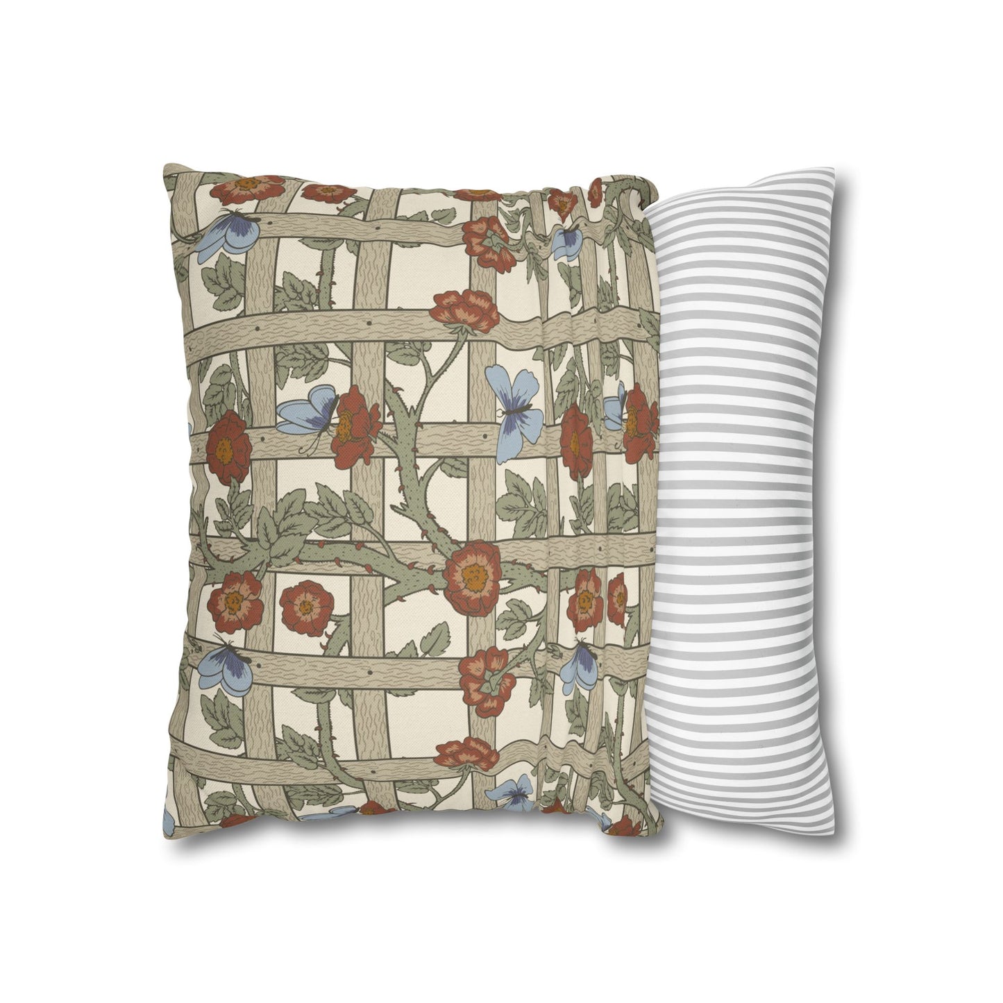 Decorative pillow with floral pattern next to a striped pillow on a white background