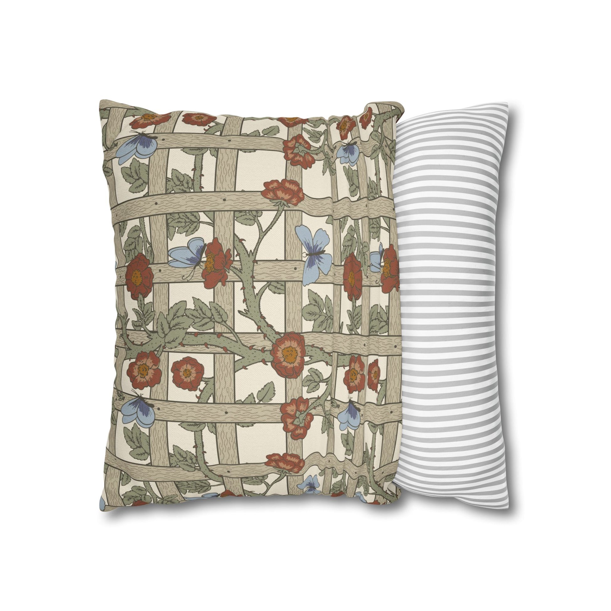 Decorative pillow with floral pattern next to a striped pillow on a white background