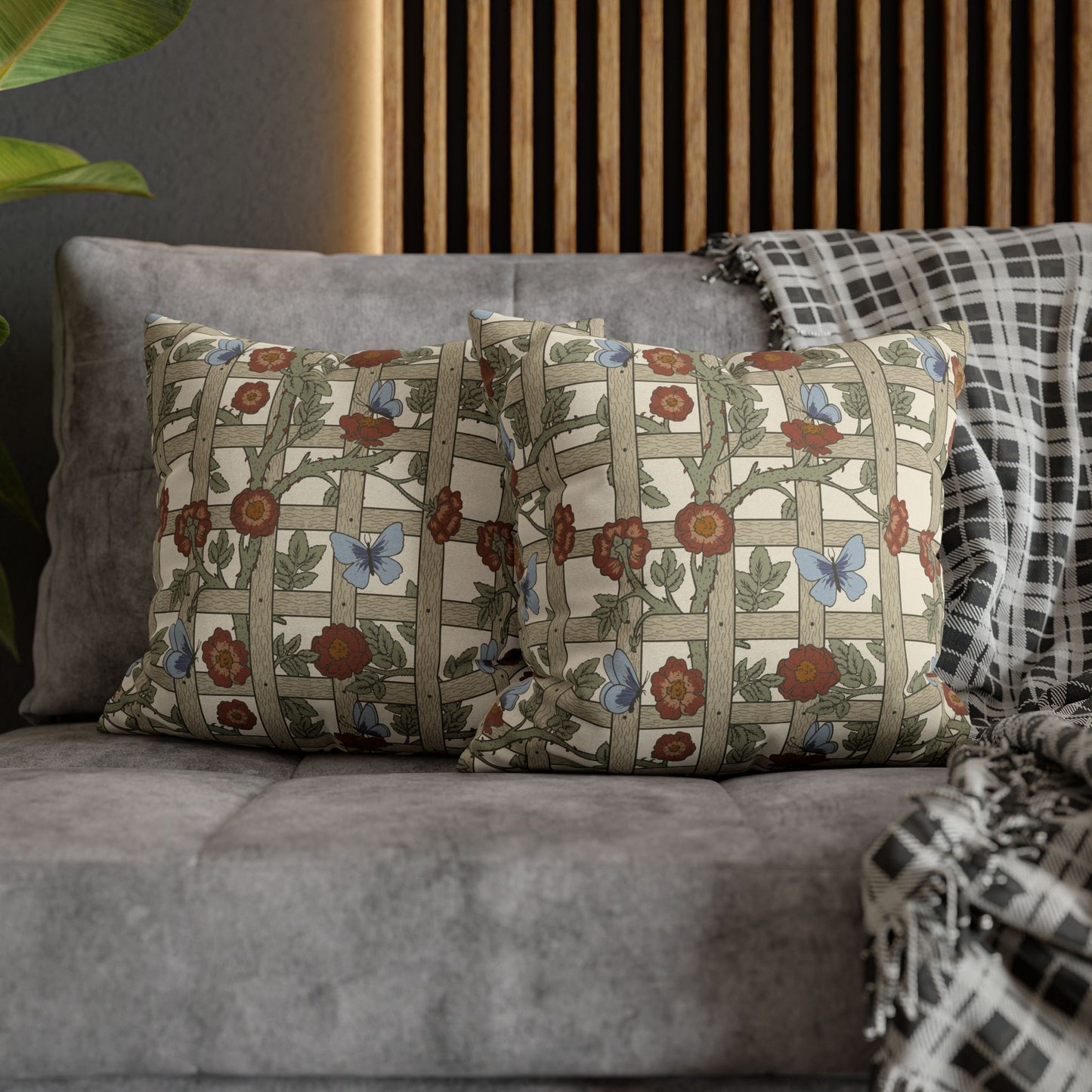 Decorative pillows with floral patterns on a gray sofa.