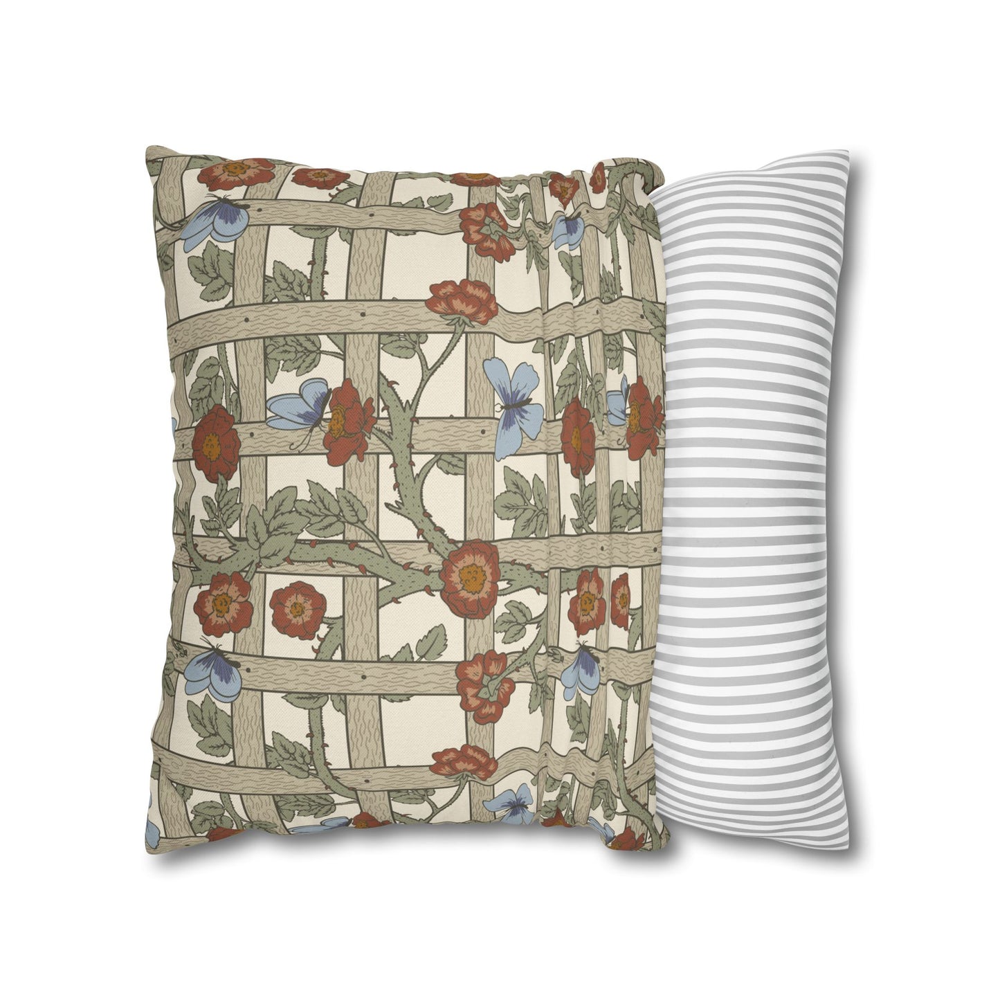 Decorative pillow with floral and lattice pattern next to a striped pillow on a white background