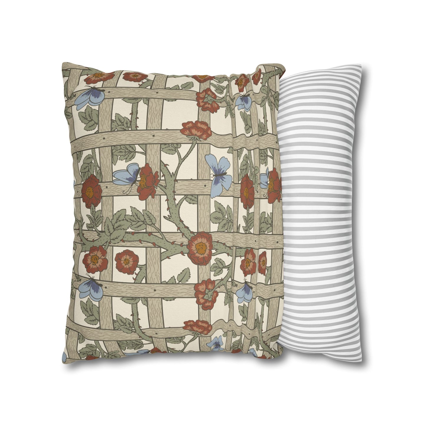 Decorative pillow with floral and lattice design next to a striped pillow on a white background