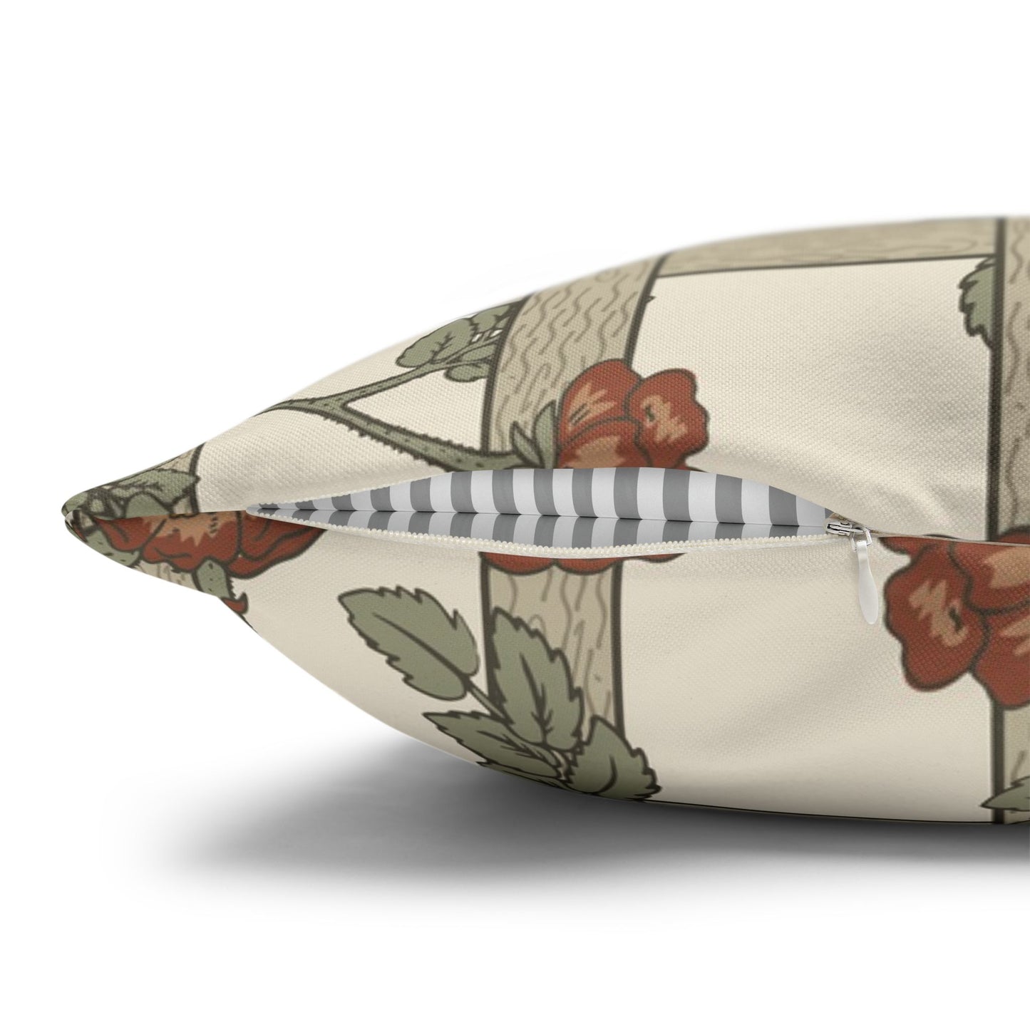 Floral-patterned pillow with a striped accent on a white background